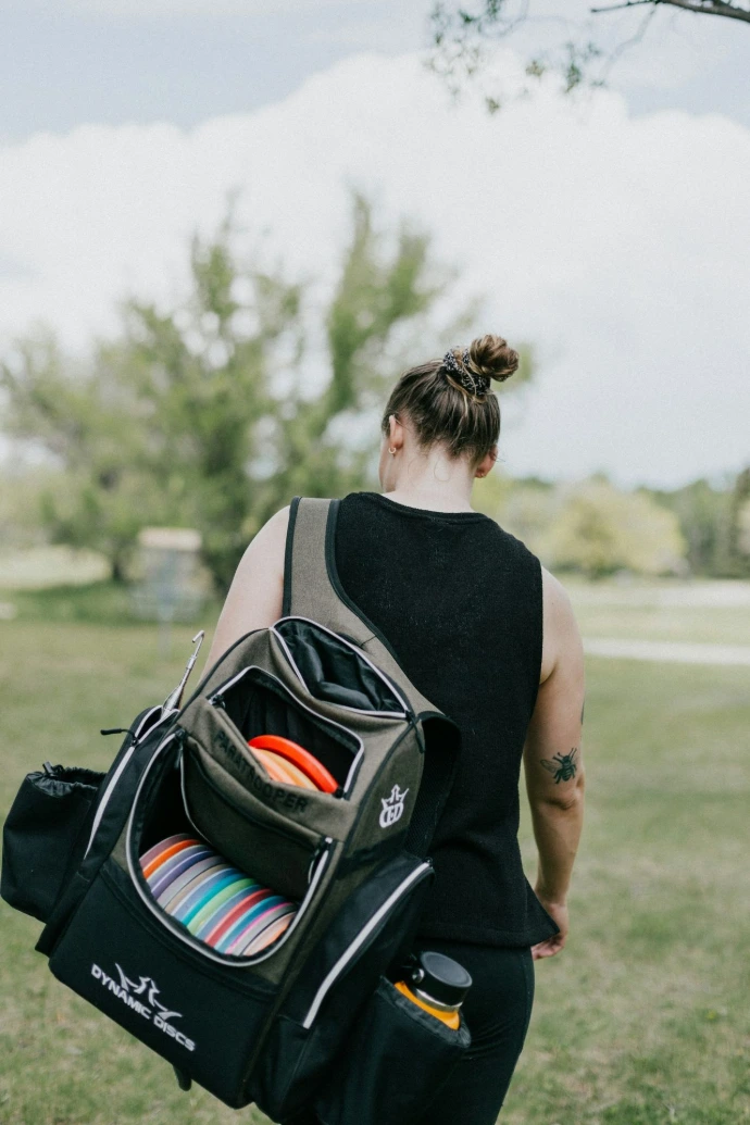 a woman with a fisc golf bag